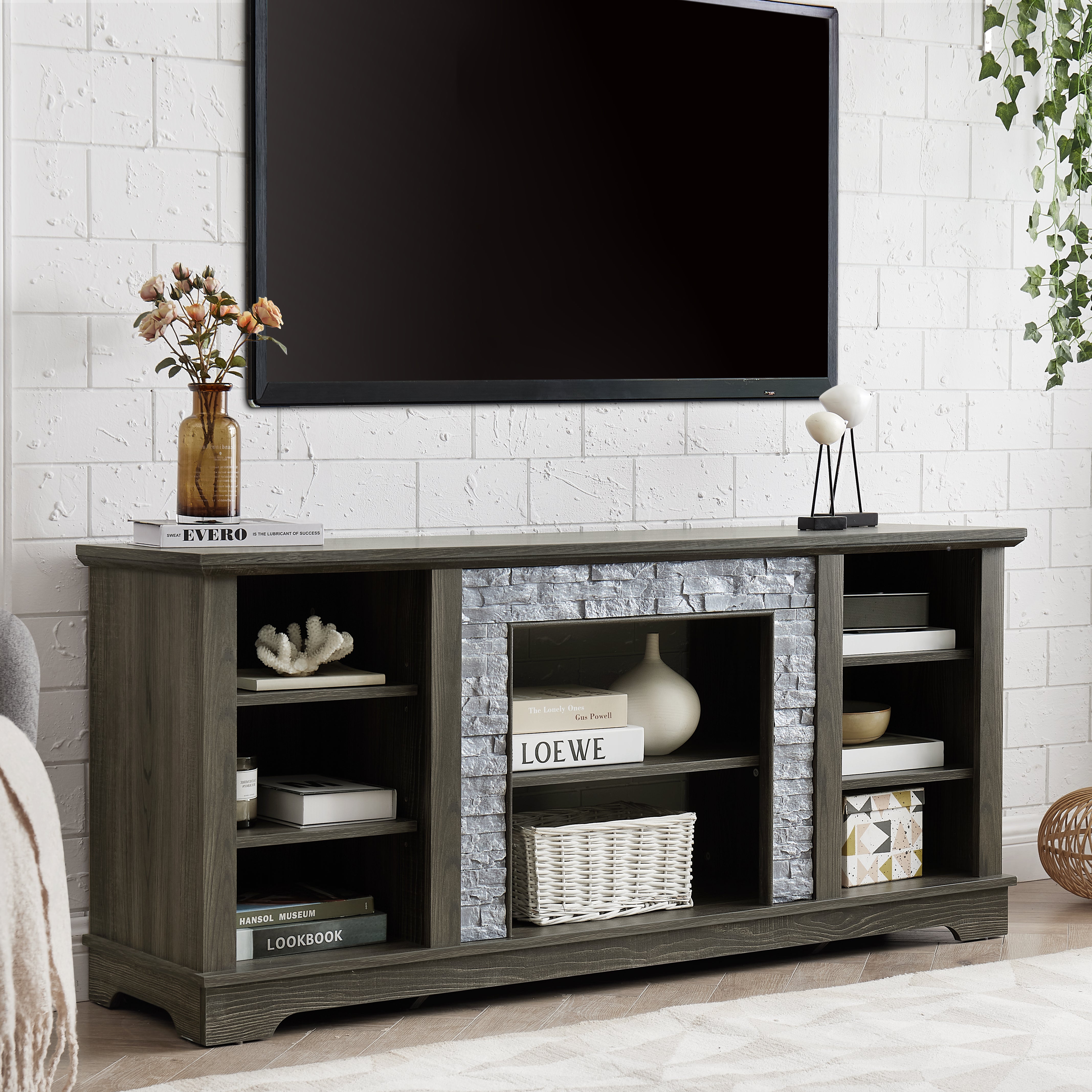 Mantel Stone modern entertainment console, manually stacked stone surrounds open storage space, gray