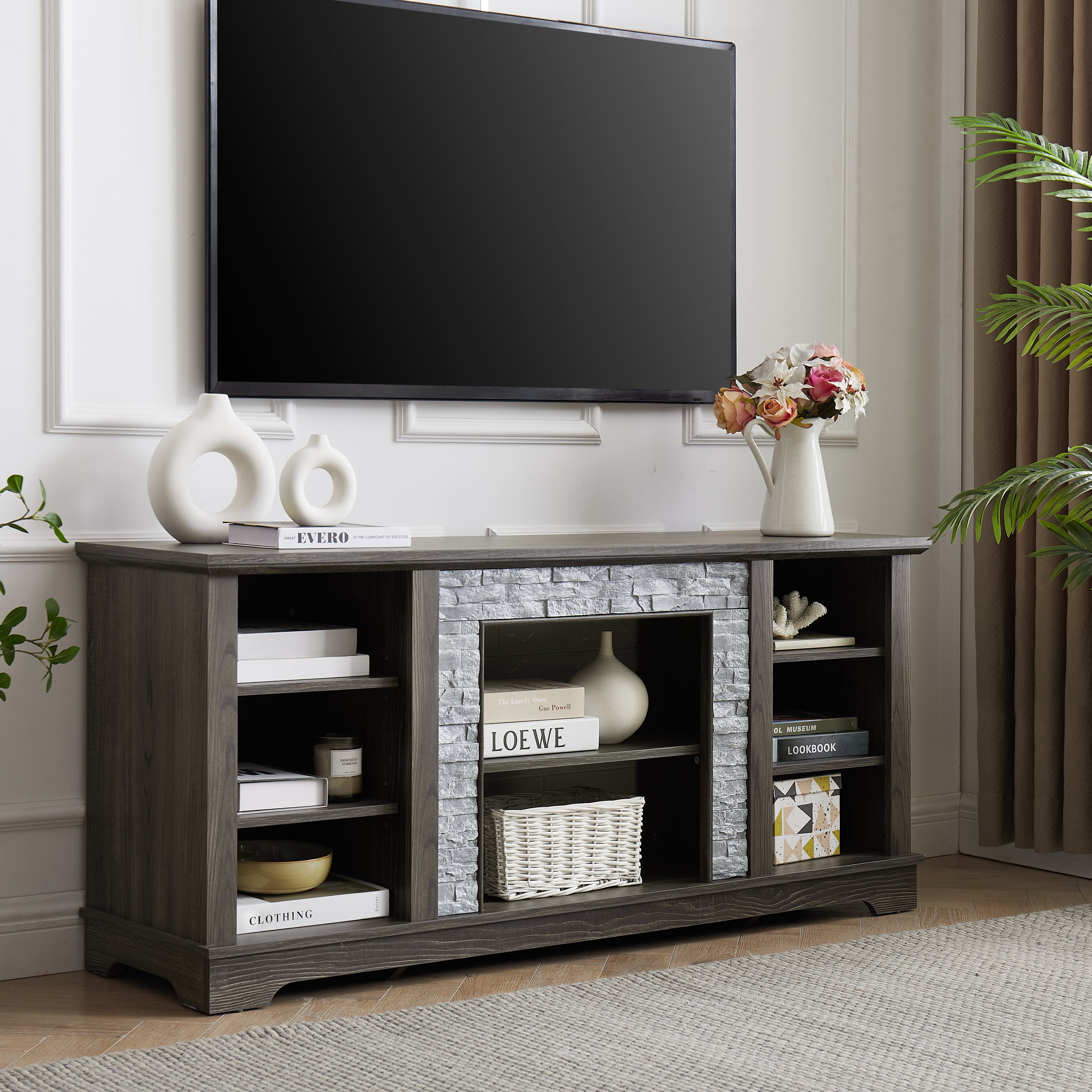 Mantel Stone modern entertainment console, manually stacked stone surrounds open storage space, gray